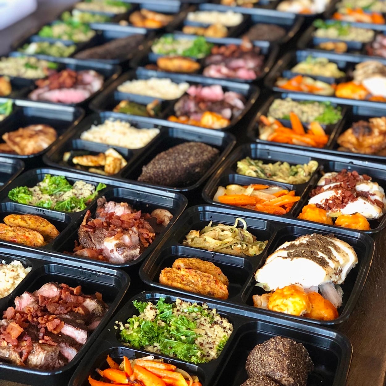 Weekly meal preparation by Chef Olintho: portioned proteins, grains, and vegetables